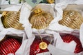 Christmas ornaments. Christmas market store - Gold and red decorations balls in boxes Royalty Free Stock Photo