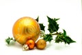 Christmas ornaments - orange ball with green holly Royalty Free Stock Photo