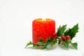 Christmas ornaments - red candle and green holly Royalty Free Stock Photo