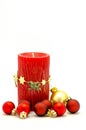 Christmas ornaments - red candle and red and gold ornaments Royalty Free Stock Photo