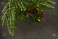 Christmas ornaments with small red berries, bright balls, red candles and a pine branch