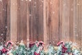 Christmas ornaments with snow on wood background Royalty Free Stock Photo