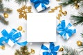Christmas ornaments. White gift box with blue ribbon, New Year balls and Christmas tree in xmas composition on white background Royalty Free Stock Photo