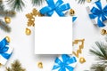 Christmas ornaments. White gift box with blue ribbon, New Year balls and Christmas tree in xmas composition on white background Royalty Free Stock Photo