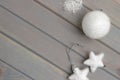 Christmas ornaments in white on a light gray wooden background. New Year`s accessories. View from above. Royalty Free Stock Photo