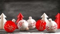 Christmas ornaments on a wooden table with a blackboard background.