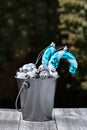 Christmas Ornamnets Collected in Silver Bucket on Wooden Table