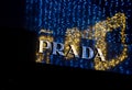 Christmas outdoor decorative lights reflecting in the fashion boutique Prada, luxury brand