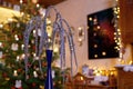 Christmas Palm made of Glitter Branches in Front of Christmas Tree in Festively Illuminated Family Room Royalty Free Stock Photo