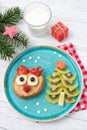 Christmas pancake in a shape of reindeer made of fresh fruits and berries and kiwi christmas tree. Healthy food for kids ideas. Royalty Free Stock Photo