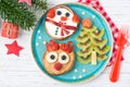 Christmas pancakes in a shape of deer and snowman made of fresh fruits and berries and kiwi Christmas tree. Healthy food for kids Royalty Free Stock Photo