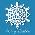 Christmas paper snowflake on blue background.