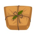 Christmas parcel in craft paper with rope and holly leaves Royalty Free Stock Photo