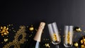 Christmas party concept. Flat lay composition with champagne bottle, glasses, golden decorations, balls, carnival mask on black Royalty Free Stock Photo