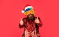 Christmas party entertainment. Funny man with beard. Christmas spirit. Cheerful clown colorful hairstyle. Winter