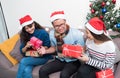 Christmas party with friends, asia people exchange gift and giving present with smiling face,Holiday xmas celebration concept Royalty Free Stock Photo