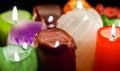 Christmas party, romantic date concept: colorful burning candles on dark background Royalty Free Stock Photo