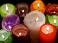 Christmas party, romantic date concept: colorful burning candles on dark background Royalty Free Stock Photo