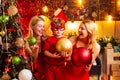 Christmas party. Women red dresses celebrate christmas with little cute baby. Family bonds. Love peace joy. Kid boy with