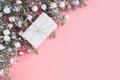 Christmas pastel composition with white gift on pink. Xmas frame with space for text. View from above