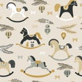 Christmas pattern with childish rocking horses on beige background. Pine branch. Holiday design for Textile, Fabrics Royalty Free Stock Photo