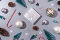 christmas pattern with decorations, frame made of gifts, candy canes, balls and trees on gray background, flat lay Royalty Free Stock Photo