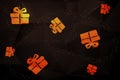 Christmas pattern made from golden present boxes on black Royalty Free Stock Photo