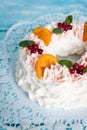 Christmas pavlova cake wreath decorated with cranberry, carmelized orange slices and mint