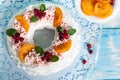 Christmas pavlova cake wreath decorated with cranberry, carmelized orange slices and mint