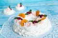 Christmas pavlova cake wreath decorated with cranberry, carmelized orange slices and mint
