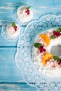 Christmas pavlova cake wreath decorated with cranberry, carmelized orange slices and mint