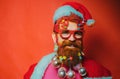 Christmas people celebration New Year. Bearded modern Santa Claus in Christmas Portrait of a Santa Claus on red