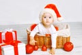Christmas and people concept - charming baby with gifts