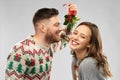 Happy couple kissing under the mistletoe