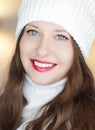 Christmas, people and winter holiday concept. Happy smiling woman wearing white knitted hat as closeup face xmas Royalty Free Stock Photo