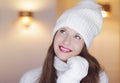 Christmas, people and winter holiday concept. Happy smiling woman wearing white knitted hat as closeup face xmas Royalty Free Stock Photo