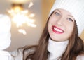 Christmas, people and winter holiday concept. Happy smiling woman wearing white knitted hat as closeup face xmas Royalty Free Stock Photo