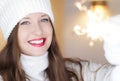 Christmas, people and winter holiday concept. Happy smiling woman wearing white knitted hat as closeup face xmas Royalty Free Stock Photo