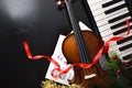 Christmas performance concept with violin and piano on black table Royalty Free Stock Photo