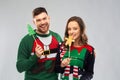 Couple with christmas party props in ugly sweaters Royalty Free Stock Photo