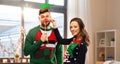 Couple with christmas party props in ugly sweaters Royalty Free Stock Photo