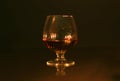 Christmas photo cognac glass and candle on black background Royalty Free Stock Photo