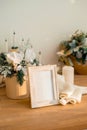 Christmas photo frame mock up template with decoration on wooden table. Royalty Free Stock Photo