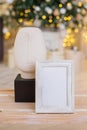 Christmas photo frame mock up template with decoration on wooden table. Royalty Free Stock Photo