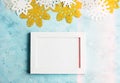 Christmas photo frame mockup: white, gold and silver paper snowflakes on blue background. Lettering Royalty Free Stock Photo