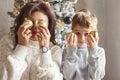 Christmas photo of happy family mother and little son holding xmas tree toy balls near face Royalty Free Stock Photo