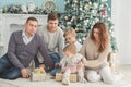 Christmas photo of large family. joy and happiness concept. portrait of large family gathering. sitting on floor, getting gifts, Royalty Free Stock Photo