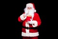 Christmas. Photo of Santa Claus gloved hand With a red bucket with popcorn, on a black background Royalty Free Stock Photo