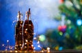 Christmas photo of two full bottles with garland