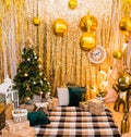 Christmas photo zone with a Christmas tree, garland, New Year`s decor and gifts. Christmas and New Year celebration concept